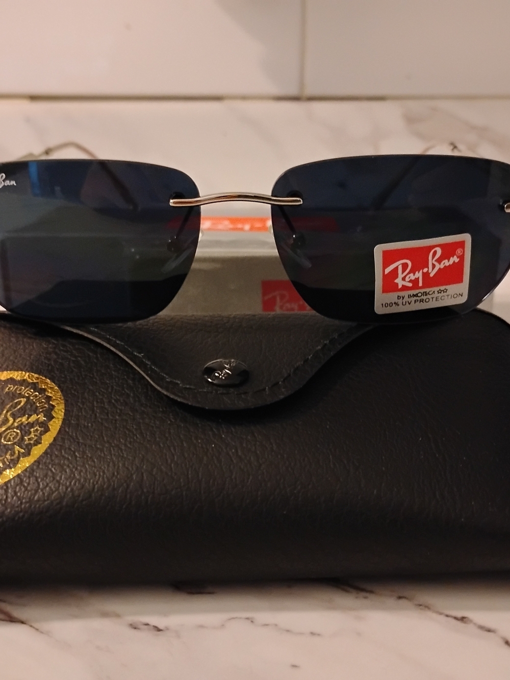 Ray-Ban Men’s Blue Lens Rimless Sunglasses